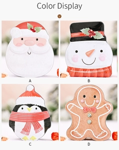 Detail of four festive Christmas tin boxes featuring Santa, Snowman, Penguin and Gingerbread Man