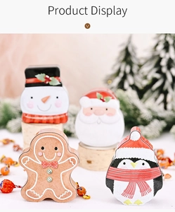 Detail showing four Christmas tin gift boxes with Santa, Penguin, and Snowman cartoon prints