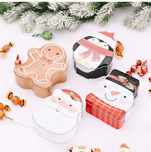 Detail of Christmas tin boxes featuring embossed Santa, Penguin and Snowman motifs
