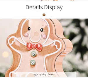 Detailed view of gingerbread man tin box with festive bow on Christmas tree background