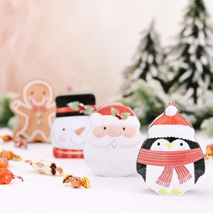 Christmas tin box set with Santa, snowman, penguin, and gingerbread man designs