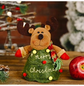 Detail of Christmas reindeer plush in tree costume with Merry Christmas embroidery