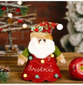 Close-up of Santa Claus plush candy bag with Merry Christmas embroidery and fuzzy pom-poms