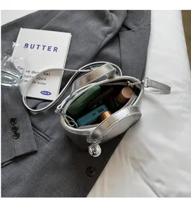 Top-down view of spacious interior of silver metallic bucket bag showing daily essentials