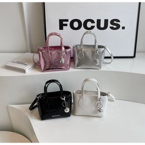 Minimalist bucket bags in four colors featuring sleek metallic and matte finishes with charms