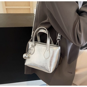Detail of silver metallic mini bucket bag with textured pleats and sphere charm