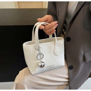 Detail of white mini bucket bag with FASHION & YM print and silver metal ball charm