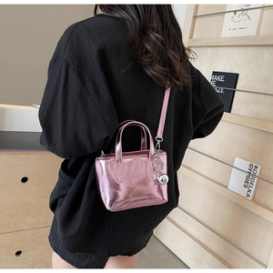 Detail of metallic pink wrinkled leather mini tote bag with silver ball charm