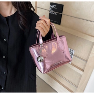 Detail of metallic pink bucket bag with wrinkled texture and silver ball ornament