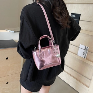 Metallic pink mini tote bucket bag with silver ball pendant and crossbody strap