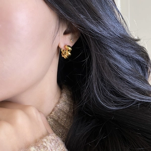 Elegant gold twisted hoop earrings with a minimalist spiral metal design for women