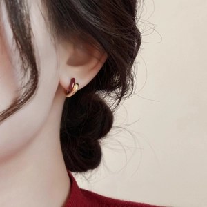 French vintage style red enamel and gold plated hoop earrings worn on a model ear