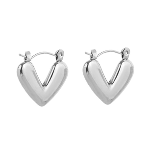 Macro shot of silver V-shaped heart earrings with a polished smooth metallic finish