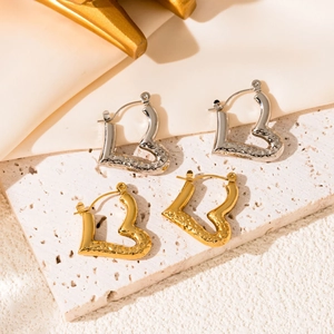 Polished gold and silver heart hoop earrings with hammered texture on stone base