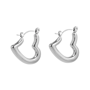 Detail shot of irregular silver heart hoop earrings with a high-polished mirror finish