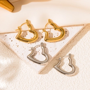 Minimalist heart hoop earrings in polished gold and silver stainless steel finish