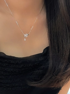 Detail of a 925 silver planet necklace with Only lettering and teardrop zircon pendant