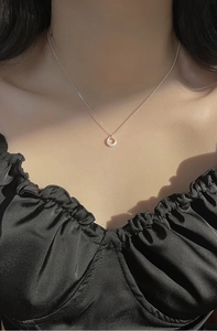 Gros plan du collier minimaliste avec pendentif cercle en argent S925 sur modèle