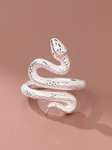 Detailed view of silver snake ring with scale texture and green zircon eyes
