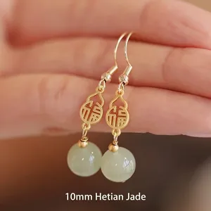 Faux Hetian jade gourd earrings with gold character charms and green stone drops