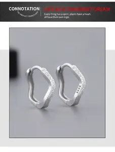 Close-up of S925 sterling silver hoop earrings with irregular frosted matte texture