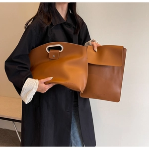 Caramel leather briefcase set with hollow metal handles and embossed brand logo detail