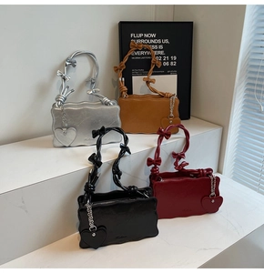 Detailed display of four wave-edged shoulder bags with bow handles and heart charms