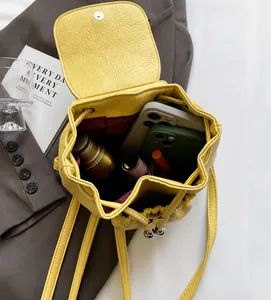 Interior detail of yellow textured leather backpack showing spacious storage capacity