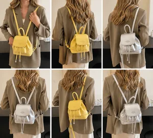 Litchi pattern mini backpack with adjustable straps and drawstring closure detail