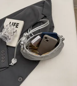 Spacious interior of silver cloud bag showing capacity for phones and lipstick