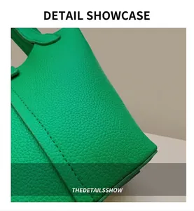 Close-up of green bucket bag showing litchi grain leather texture and stitching