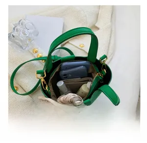 Litchi pattern green bucket bag interior view showing capacity for phones and cosmetics