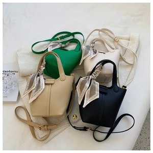 Chic bucket bags in green, white, beige, and black with silk scarf handles and litchi texture