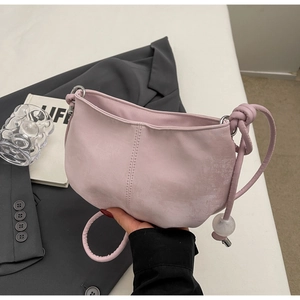 Pink crescent cloud shoulder bag with knot strap and metallic loop detail