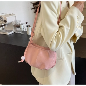 Detail of soft pink PU leather cloud bag featuring decorative knot and translucent beads