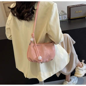 Detail of light pink soft PU leather cloud bag with marble beads and shoulder strap