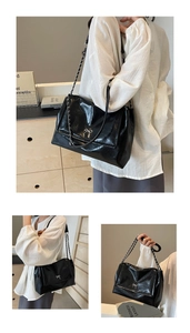 Detail of soft leather tote bag featuring a silver bow buckle and elegant chain strap