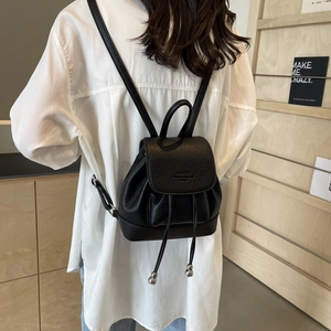 Minimalist black pebble leather backpack with drawstring and silver bead details