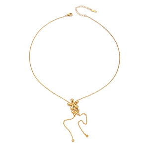Macro view of gold flower pendant necklace with elegant tassels on white background
