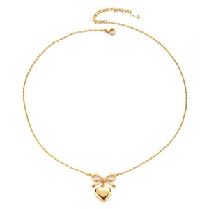 Detailed view of golden bow and heart pendants with lobster clasp and adjustable chain