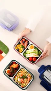 Close-up of a multi-compartment 304 stainless steel bento box with a sealed lid and cutlery