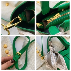 Detail of green lychee leather bucket bag with gold hardware and printed silk scarf