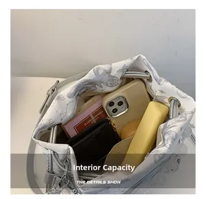 Interior view showing large capacity for phone, wallet, and cosmetics in cat bucket bag