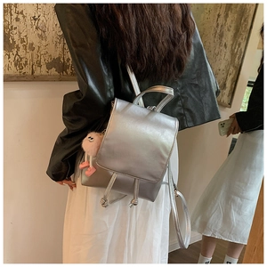 Silver PU leather mini backpack featuring a cute pink plush charm for a stylish look