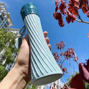 Macro detail of the 304 stainless steel blue mug featuring spiral non-slip texture and lid
