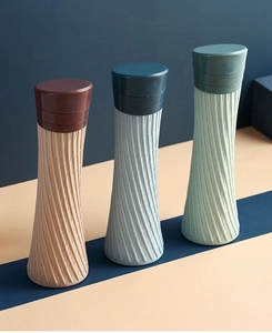 Three colorful collapsible silicone water bottles with non-slip diamond texture design