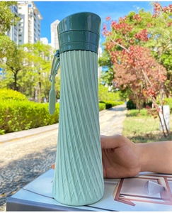 Detail of collapsible silicone bottle with diamond texture and metal carabiner clip