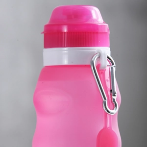 Portable pink silicone collapsible sports water bottle with a metal hiking carabiner