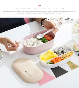 Macro view of double-layer lunch box with wood-style lid and compartments for meal prep