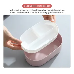 Pink oval divided lunch box with double-layer structure and white cutlery compartments